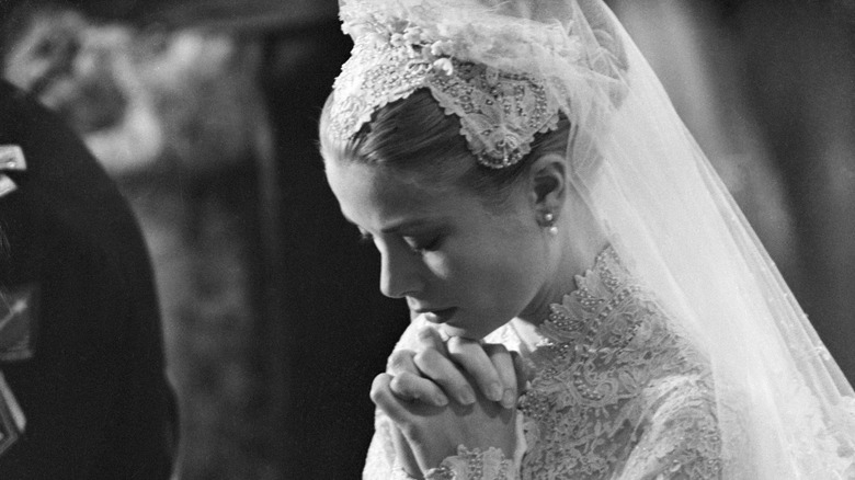 Grace Kelly kneeling in prayer during her wedding
