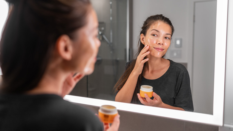 Woman applying skincare