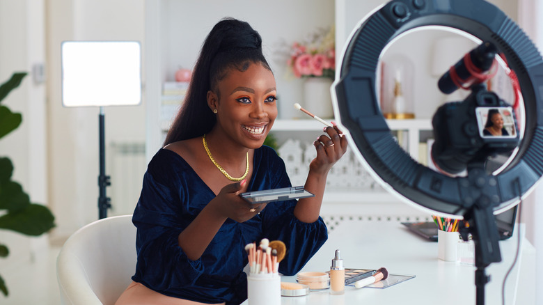 Woman recording a makeup tutorial