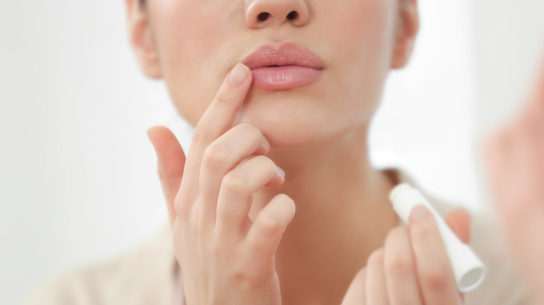 Woman applying lip balm 