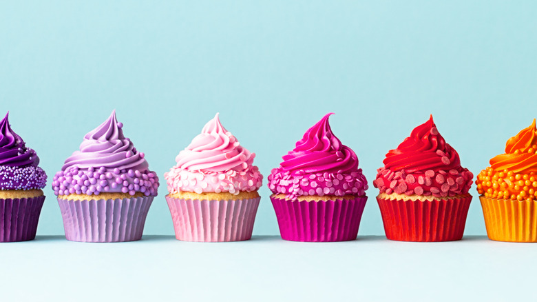 Colorful cupcakes on blue background