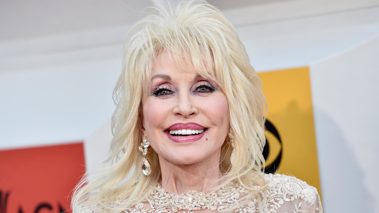 Dolly Parton smiles for the camera at an event