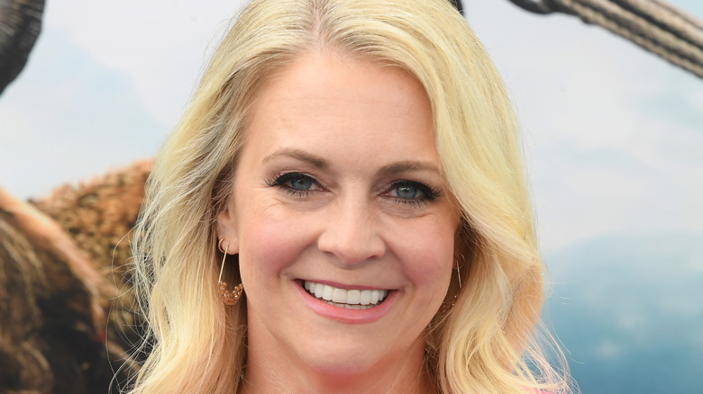 Melissa Joan Hart smiling while posing at an event in a pink dress