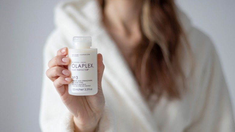 woman holding Olaplex No. 3