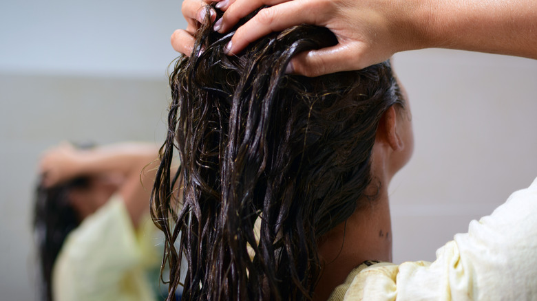woman applying hair treatment