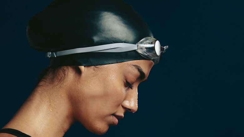 Black swimmer wearing swim cap