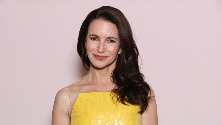 Kristin Davis in yellow dress with hair over one shoulder