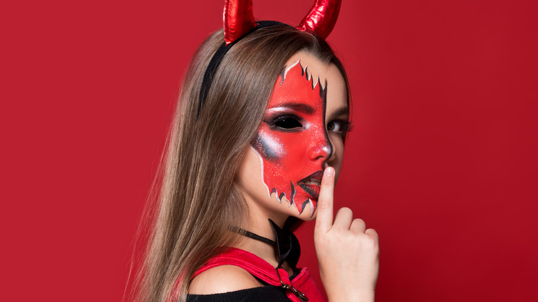 Woman dressed in devilishly elegant costume