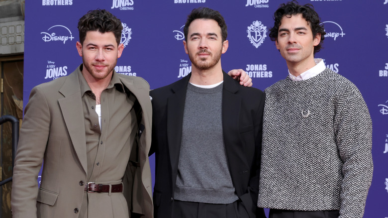 Nick Jonas, Kevin Jonas, and Joe Jonas smile for a photo at the Hand and Footprint Ceremony at TCL Chinese Theatre