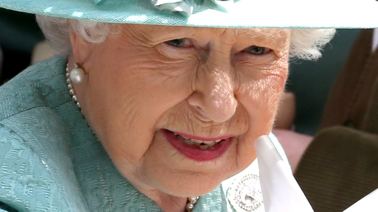 Queen Elizabeth II wearing aqua hat and dress