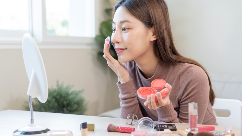 Woman applying blush