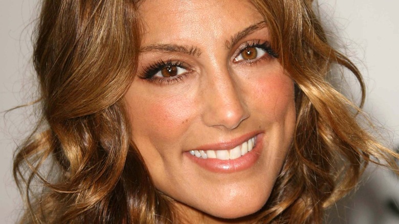 Jennifer Esposito smiling on the red carpet.