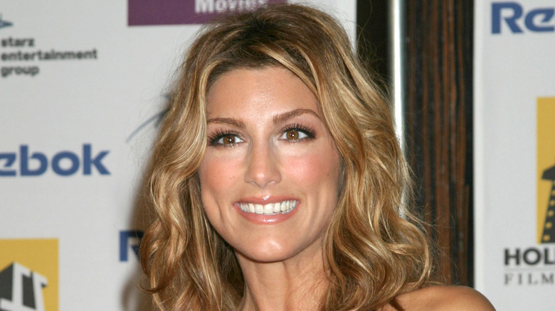 Jennifer Esposito smiling on the red carpet