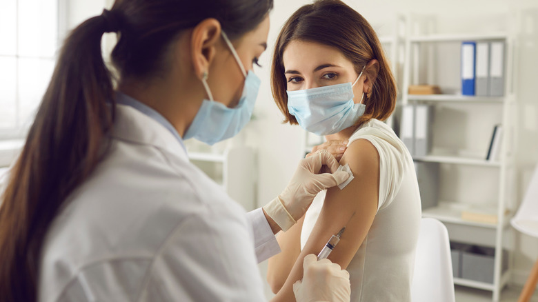 young woman getting COVID shot