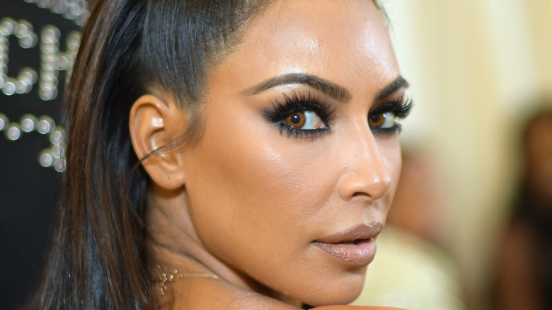 Kim Kardashian looks over her shoulder