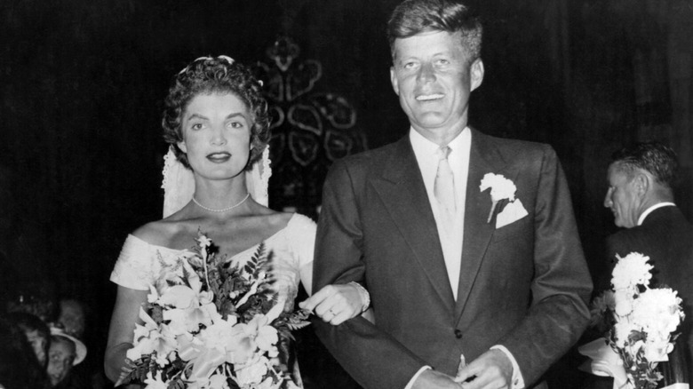 (l-r): Jacqueline Kennedy Onassis and John F. Kennedy, Sr. embracing on their wedding day.