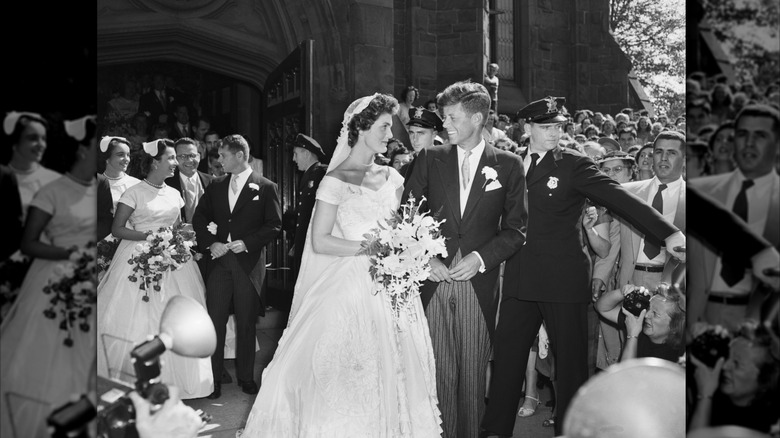 (l-r): Jacqueline Kennedy Onassis smiling at her husband, former President John F. Kennedy, Jr. on their wedding day.