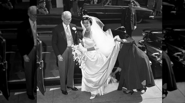 (l-r): Joseph Kennedy and Jean Kennedy standing next to a car on her wedding day
