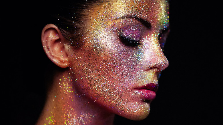 Woman covered in glittery makeup