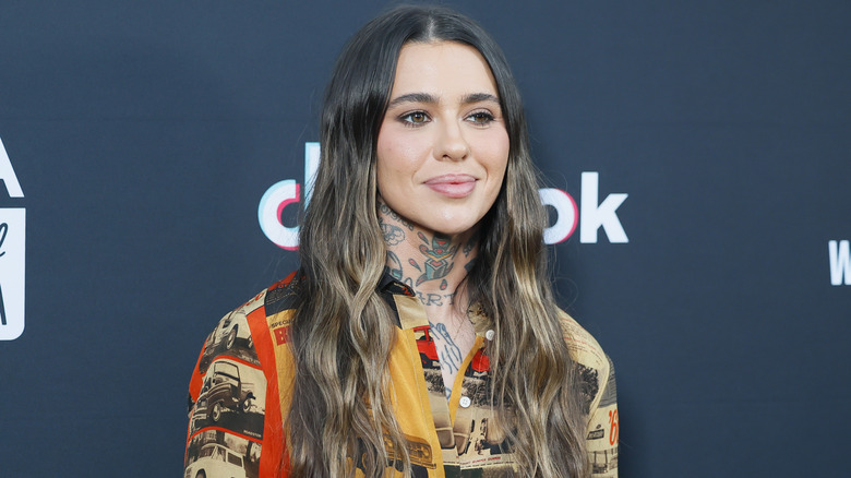 Morgan Wade slightly smiling while posing on the red carpet