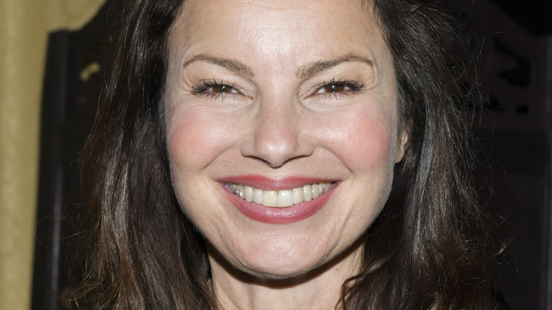 Fran Drescher smiling with red lip