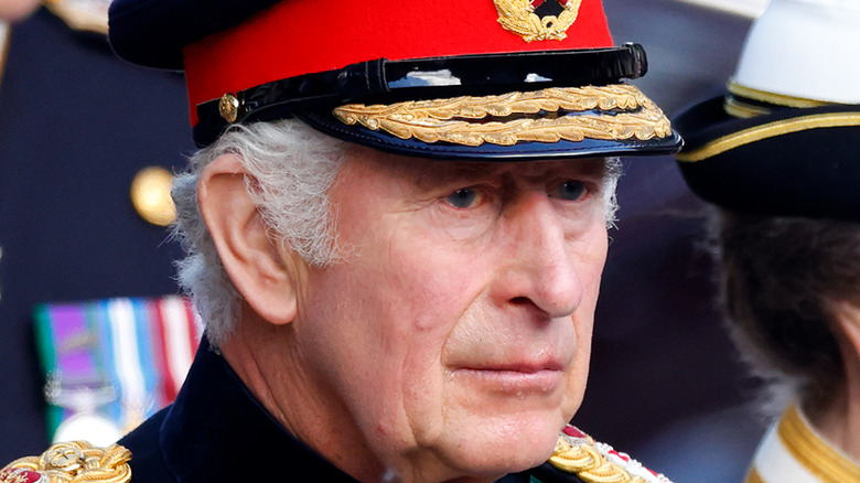 King Charles III frowning