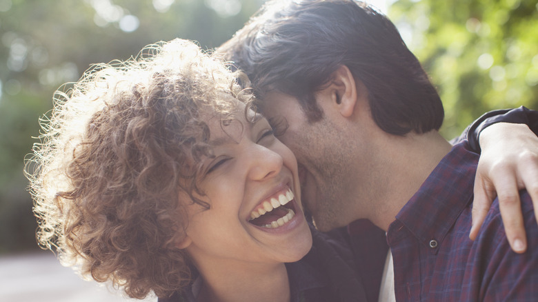 laughing woman hugging man