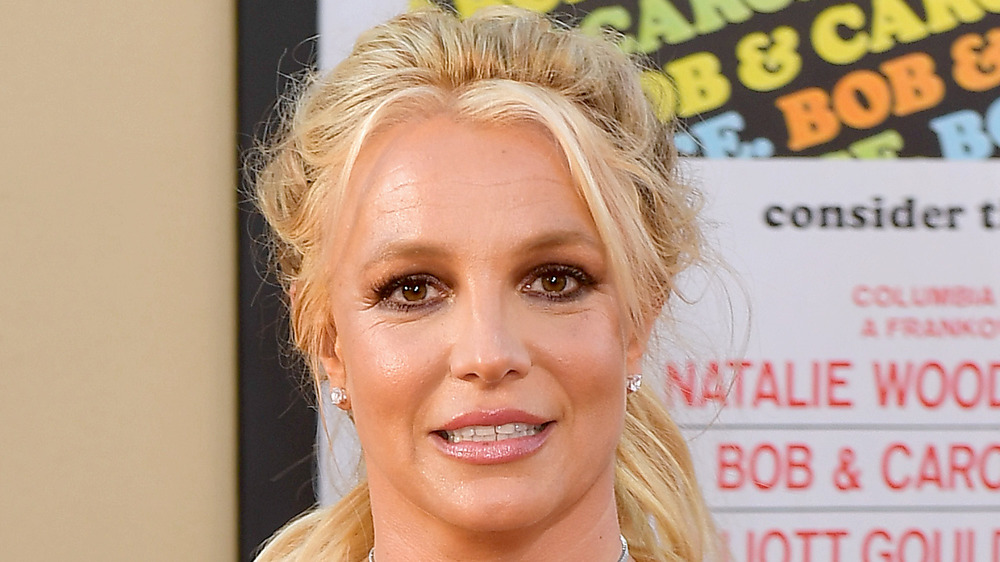 Britney Spears smiles on the red carpet in red dress