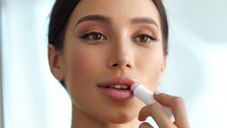 woman applying lip balm