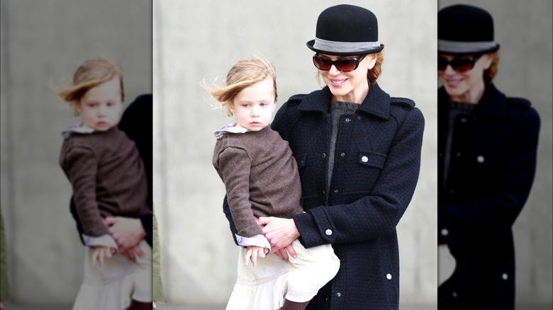 Nicole Kidman wearing a black hat, carrying Sunday Rose Kidman-Urban in New York in 2010