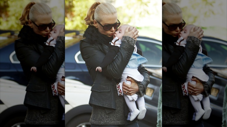 Nicole Kidman cradling Sunday Rose Kidman-Urban's head outdoors