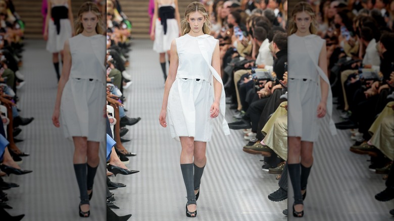 Sunday Rose Kidman-Urban walking the runway in a white dress during the Miu Miu Paris Womenswear Spring-Summer 2025 show