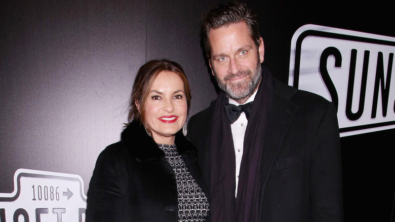 Mariska Hargitay and her husband Peter Hermann smiling and wearing black coats