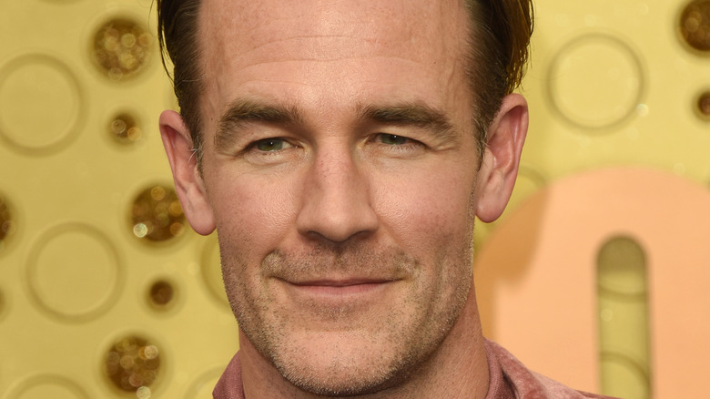 James Van Der Beek grinning at an event