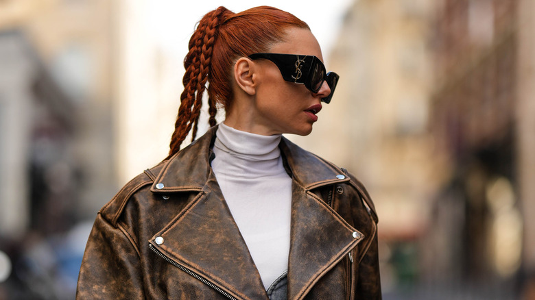 woman layering turtleneck and leather jacket