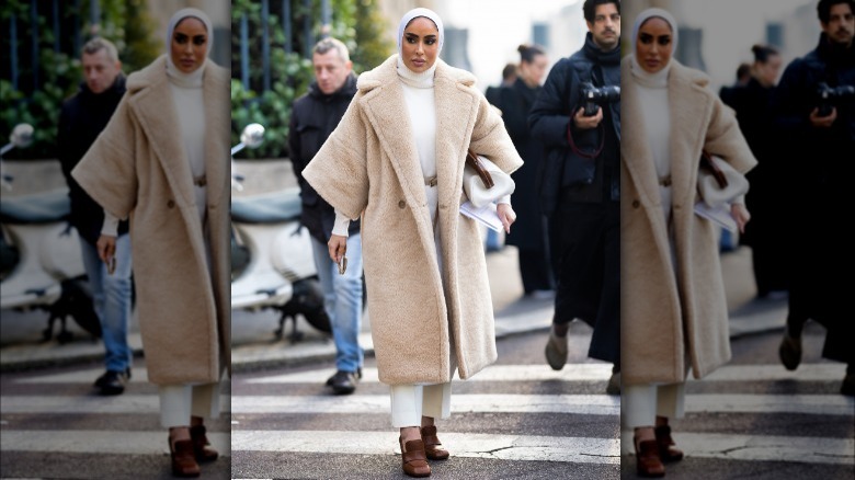 woman wearing white turtleneck under coat