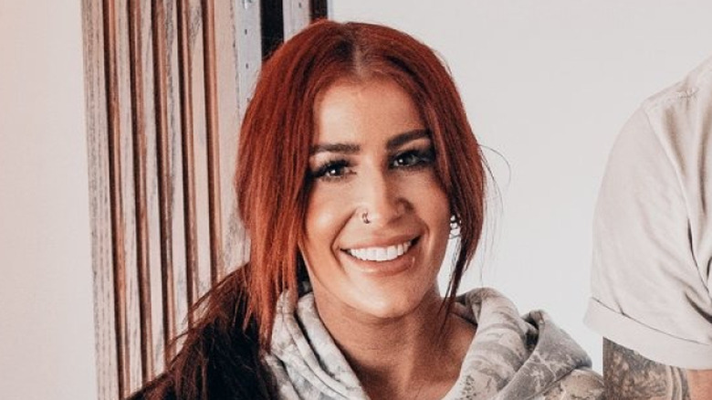 Chelsea Houska DeBoer smiling with man's arm and torso also visible