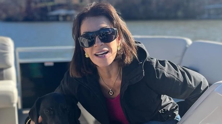 Hilary Farr sitting on boat with dog