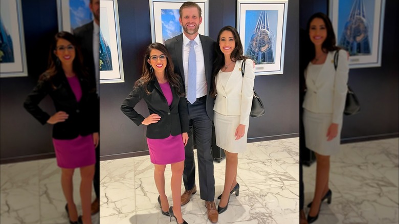 Lauren Boebert smiling in a black blazer and purple dress while next to Eric Trump and Anna Paulina Luna.