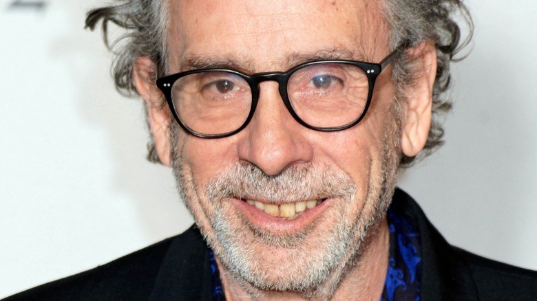 Tim Burton smiling with glasses on