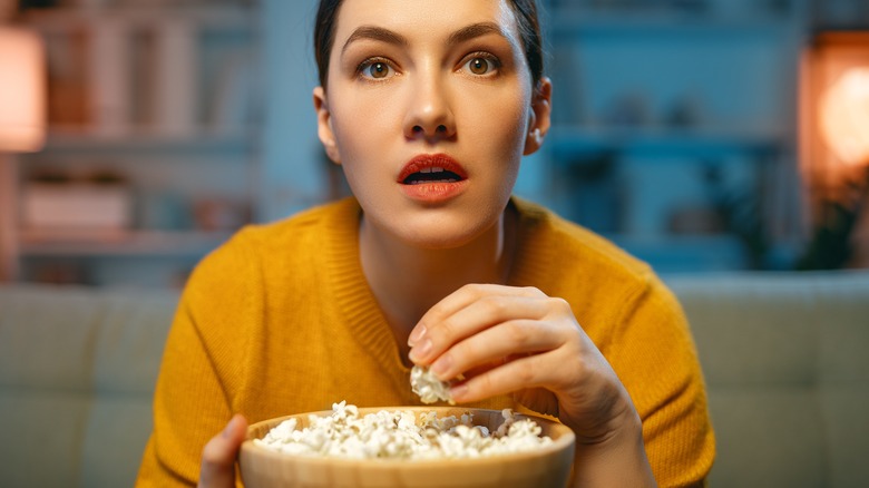 Woman eating popcorn