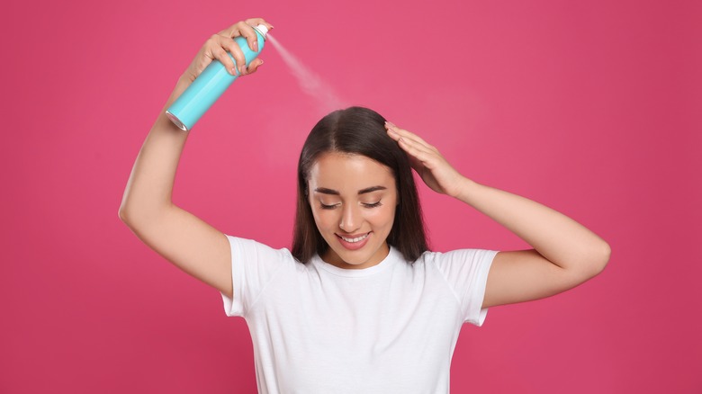 Woman using dry shampoo