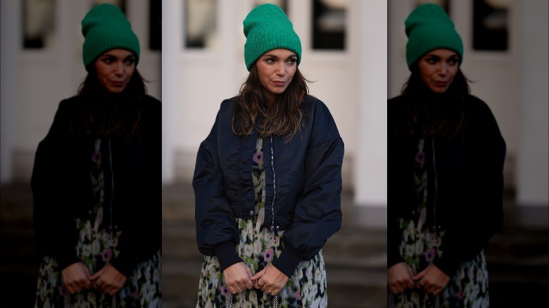 Woman wearing bomber jacket and beanie
