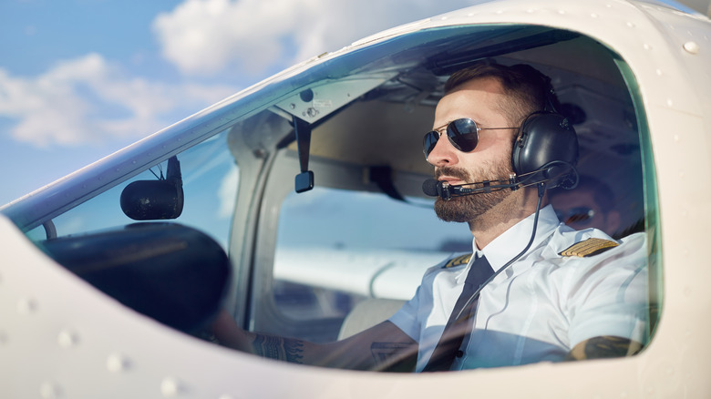 Pilot wears sunglasses in cockpit