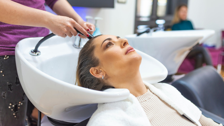 Woman getting her hair washed in a salon