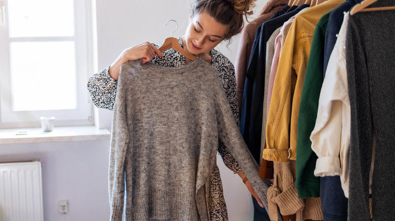 Woman picking outfit from closet