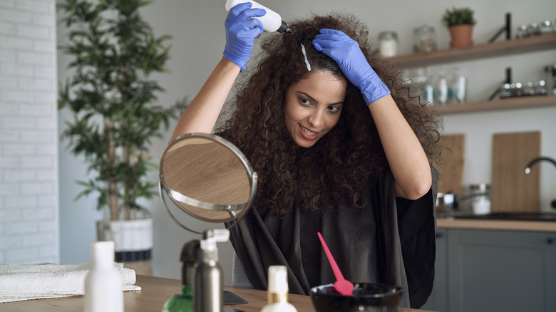 Woman dyeing her hair at home