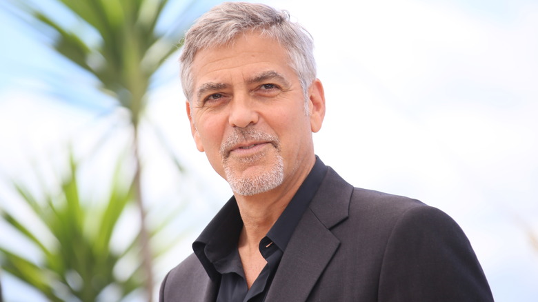 George Clooney smiling in black shirt