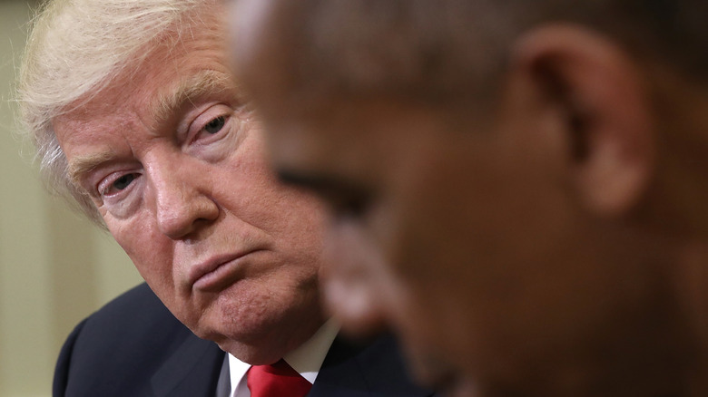 Donald Trump glaring at Barack Obama