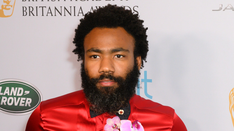 Donald Glover wearing a red shirt
